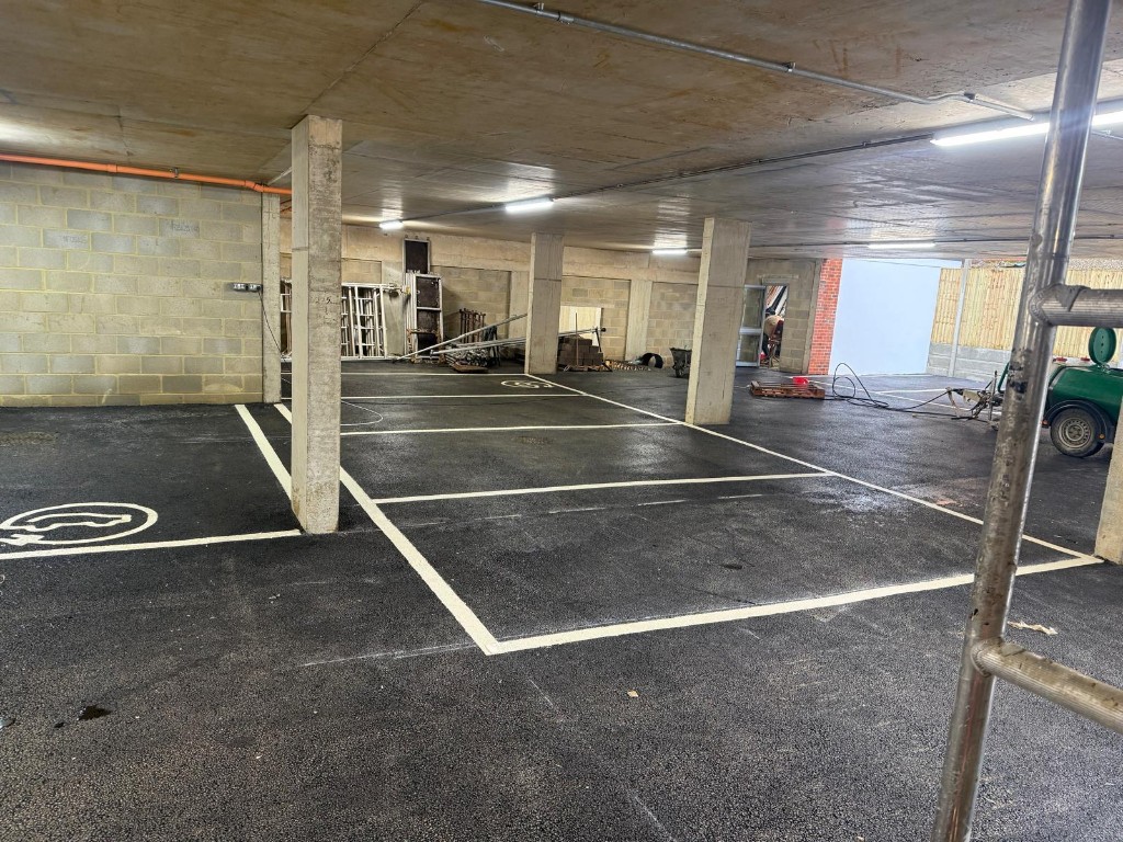Machine-laid asphalt surfacing on a commercial scheme