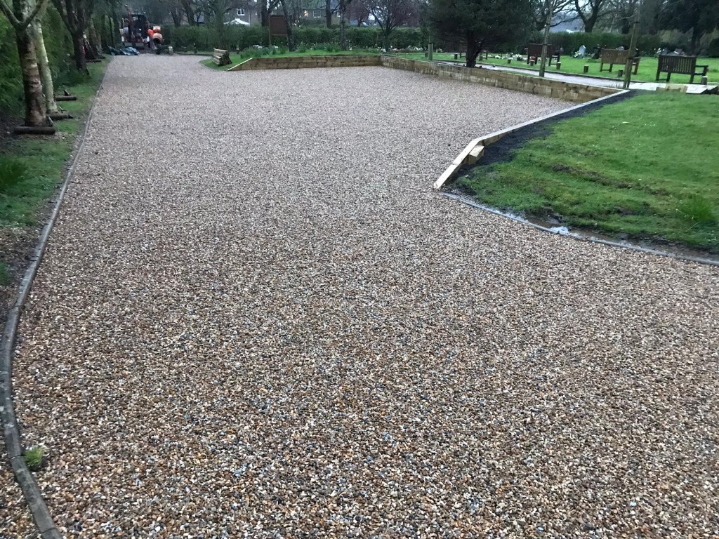 Gravel or shingle driveway with curved edging and timber sleeper borders